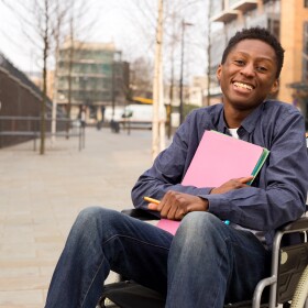 A happy young man embracing his journey through college