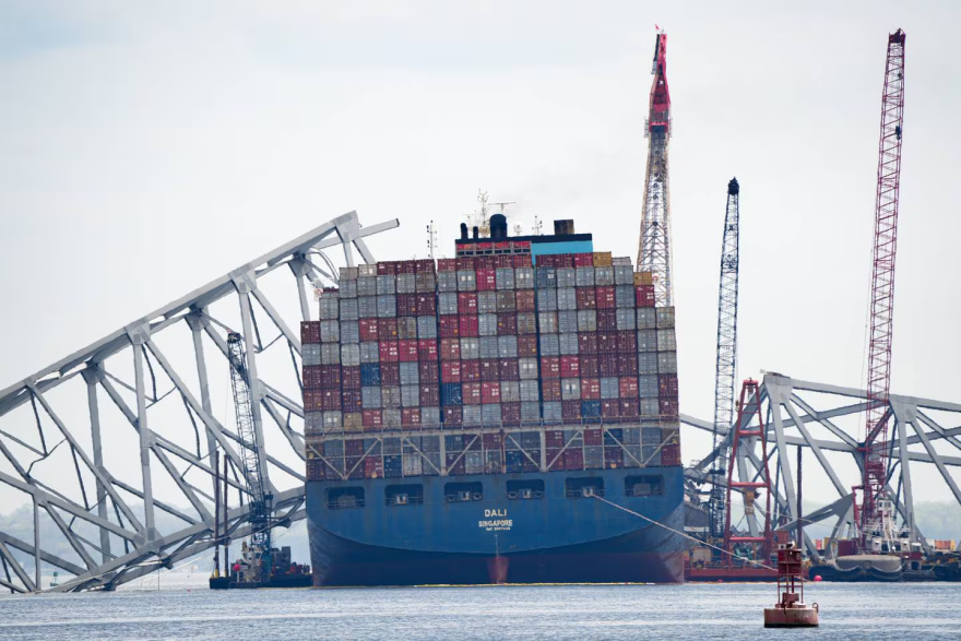 The Dali cargo ship and the collapsed Francis Scott Key Bridge are seen from a Department of Natural Resources boat on the Patapsco River in Baltimore, on April 10, 2024. (Ulysses Muñoz/The Baltimore Banner)