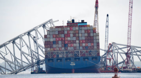 The Dali cargo ship and the collapsed Francis Scott Key Bridge are seen from a Department of Natural Resources boat on the Patapsco River in Baltimore, on April 10, 2024. (Ulysses Muñoz/The Baltimore Banner)