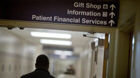 A sign points visitors toward the financial services department at a hospital.