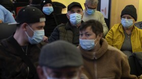 People wearing face masks as a precaution wait for a doctor appointment inside a hospital in Barcelona, Spain, Monday, Jan. 8, 2024. Regional and national health chiefs are meeting Monday to decide whether to extend mandatory mask—wearing to all health facilities following an epidemic outbreak of flu and other respiratory viruses that are putting a strain on the system. (AP Photo/Emilio Morenatti)