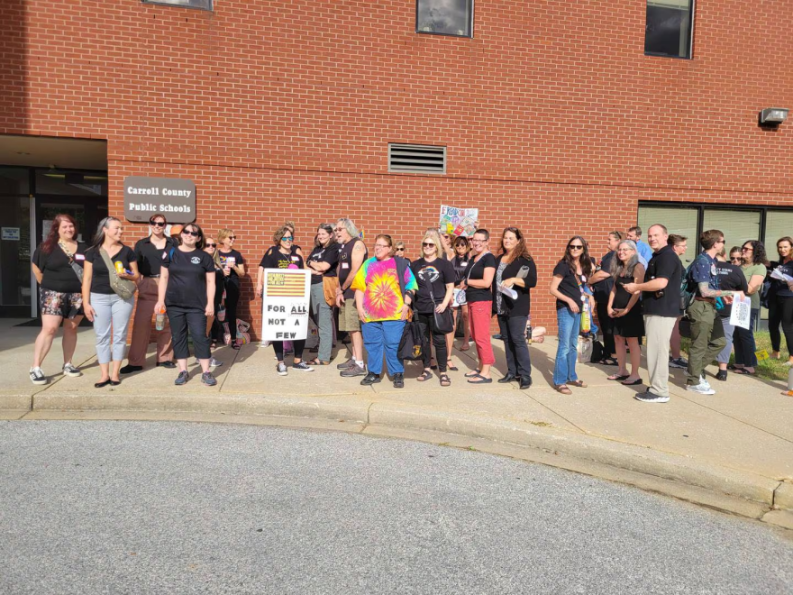 People wear black in opposition to the Carroll County superintendent’s decision to remove 56 books from school libraries until a committee reviews them. (Kristen Griffith/The Baltimore Banner)