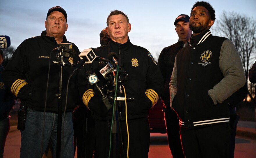 Baltimore Police Commissioner Richard Worley, with Mayor Brandon Scott (R) and Fire Department Chief James Wallace (L), speaks at a press conference early Tuesday.