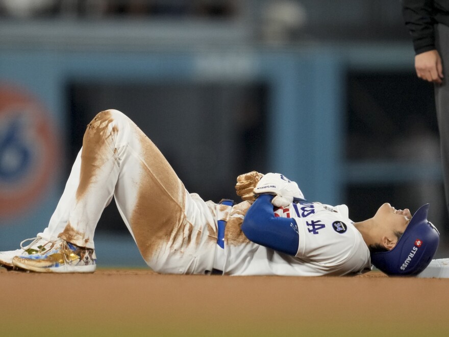 Los Angeles Dodgers' Shohei Ohtani is gets hurt sliding into second base during the seventh inning in Game 2 of the baseball World Series against the New York Yankees, Saturday, Oct. 26, 2024, in Los Angeles.