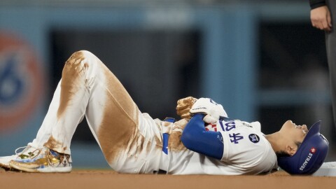 Los Angeles Dodgers' Shohei Ohtani is gets hurt sliding into second base during the seventh inning in Game 2 of the baseball World Series against the New York Yankees, Saturday, Oct. 26, 2024, in Los Angeles.