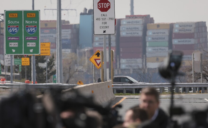 The Dali cargo ship is seen in the background of the ramp to the Key Bridge after its collapse on Tuesday.