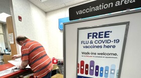 FILE - A sign for flu and covid vaccinations is displayed at a pharmacy store in Palatine, Ill., Wednesday, Sept. 13, 2023. The flu is hanging on in the U.S., intensifying in some areas of the country after weeks of apparent decline., according to data released by the U.S. Centers for Disease Control and Prevention on Friday, Feb. 9, 2024. (AP Photo/Nam Y. Huh, File)