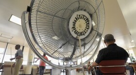 FILE - In this Thursday, June 9, 2011 file photo, seniors spend time near a fan at the Waxter Senior Center in Baltimore. The center was designated as a cooling station by Baltimore officials. Results of a study published Tuesday, Sept. 6, 2016 in the Journal of the American Medical Association suggest that in triple-digit heat, age-related changes that limit sweating might make fans less effective in those 60 and up than in young people. But the conclusion isn't clear-cut and the study authors say more research is needed. (AP Photo/Steve Ruark)