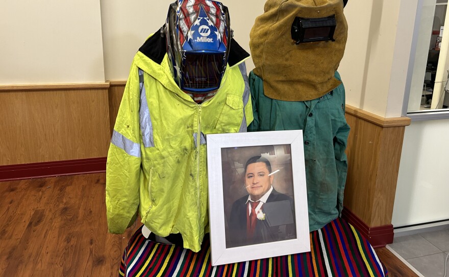 Miguel Luna’s uniform on display. A CASA spokesperson said his wife Carmen, wanted ppl to see the shrapnel from his welding. Photo by Wambui Kamau/WYPR.