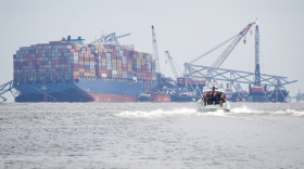 A U.S. Army Corps of Engineers boat approaches the Dali cargo ship, which toppled the Francis Scott Key bridge in March, on April 2024. (Ulysses Muñoz/The Baltimore Banner)