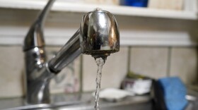 Water pours slowly out of the faucet on Saturday, Feb. 20, 2021, in Dallas, in the home of Nora Espinoza, after a handyman made a repair to a broken pipe beneath the sink. After the repair was made, another leak was discovered in a broken pipe outside of the home. (AP Photo/Tony Gutierrez)