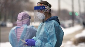 FILE - A nurse prepares for a COVID-19 test outside the Salt Lake County Health Department, Dec. 20, 2022, in Salt Lake City. The declaration of a COVID-19 public health emergency three years ago changed the lives of millions of Americans by offering increased health care coverage, beefed up food assistance and universal access to coronavirus vaccines and tests. Much of that is now coming to an end, with President Joe Biden's administration saying it plans to end the emergencies declared around the pandemic on May 11, 2023. (AP Photo/Rick Bowmer, File)