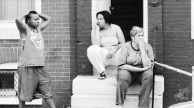 Exhausted neighbors watch police at a shooting scene in the Park Heights neighborhood of Baltimore in 2013. Photo: J.M. Giordano