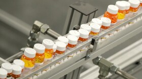 FILE- Bottles of medicine ride on a belt at a mail-in pharmacy warehouse in Florence, N.J., July 10, 2018. The Biden administration says the manufacturers of all of the first 10 prescription drugs it selected for Medicare’s first price negotiations have agreed to participate. Tuesday's announcement clears the way for talks that could lower their costs in coming years and gives the White House a potential political win heading into next year’s presidential election.  (AP Photo/Julio Cortez, File)